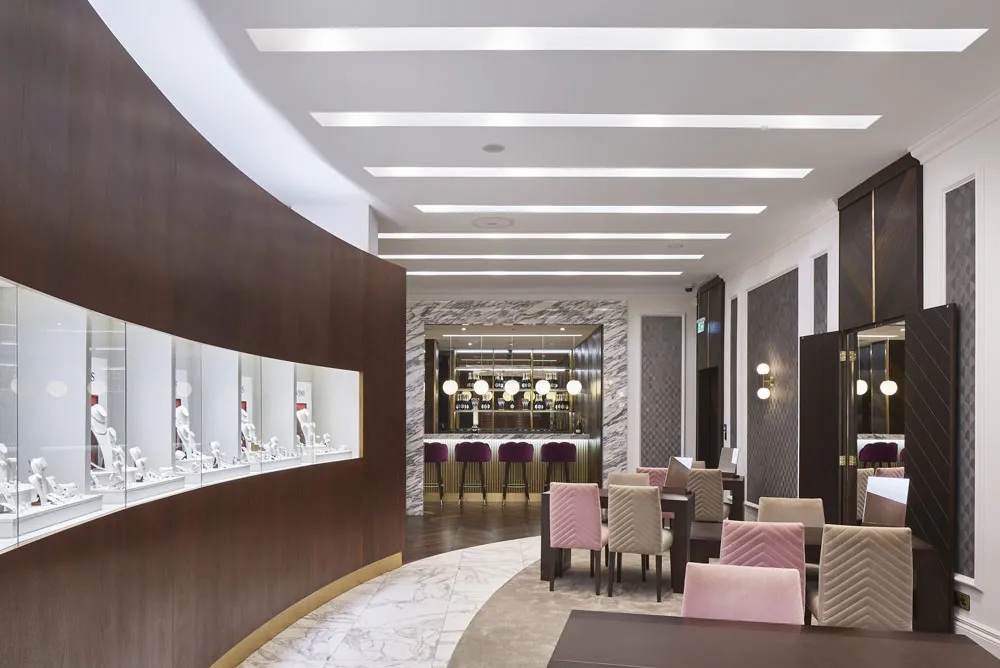 Curved display joinery and marble flooring in the Pravins jewellery boutique, Cardiff, fitted out by JPS Services
